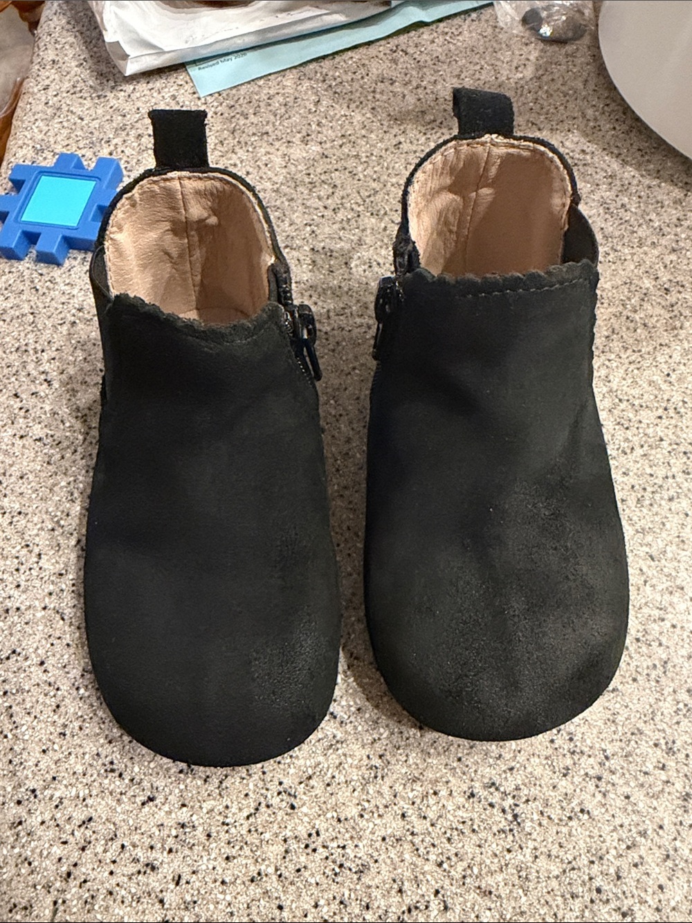 The Reagan EUC black suede boots barefoot